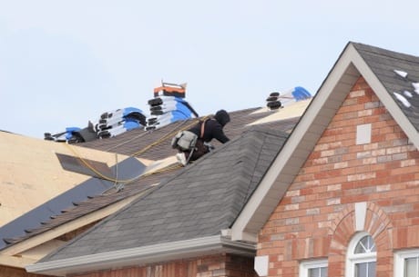 A photo of men repairing a roof